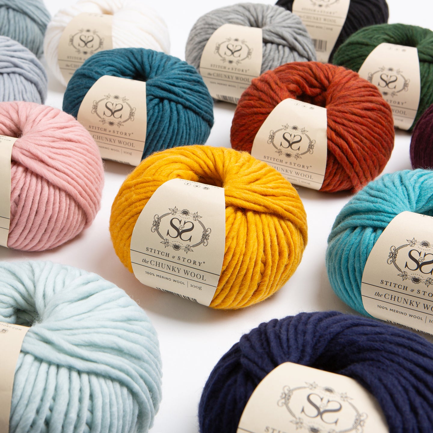 A front facing photograph showing a range of Stitch & Story 100% Merino wool The Chunky Wool, featuring 14 different colours.