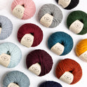 A top down photograph showing a range of Stitch & Story 100% Merino wool The Chunky Wool, featuring 14 different colours.