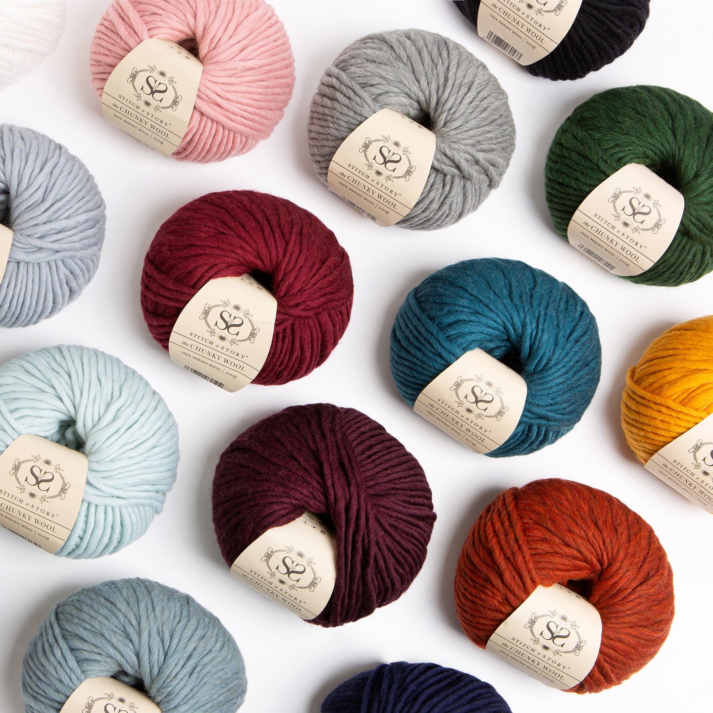 A top down photograph showing a range of Stitch & Story 100% Merino wool The Chunky Wool, featuring 14 different colours.