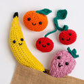 4 smiling fruits - Nana the Banana, Beryl the Raspberry, Clem the Satsuma and Cherie the Cherries are cheekily escaping from a jute bag.