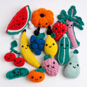 13 fruit crochet amigurumi toys crochet with Stitch & Story Cotton One are laid out on a white background with all their smiling faces looking at the camera.