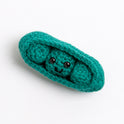 A pea in a pod toy made with Stitch & Story Cotton One in Forest Green has a joyful smiley face hiding in its pod, with 2 other pea, on a white background