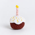 A front on photo to show the candle-lit sugar glazed crochet cupcake in brown.