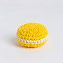 A front on photo showing the crochet lemon macaroon, made with yellow and white Stitch & Story Cotton One yarn.