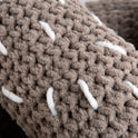 Close up to show the crochet texture of the plush giant light grey pretzel cushion made with Stitch & Story's Roly Poly Plush.