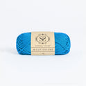 Front on photo of the Stitch & story's Cotton one yarn in 25g ball, in Sea Blue