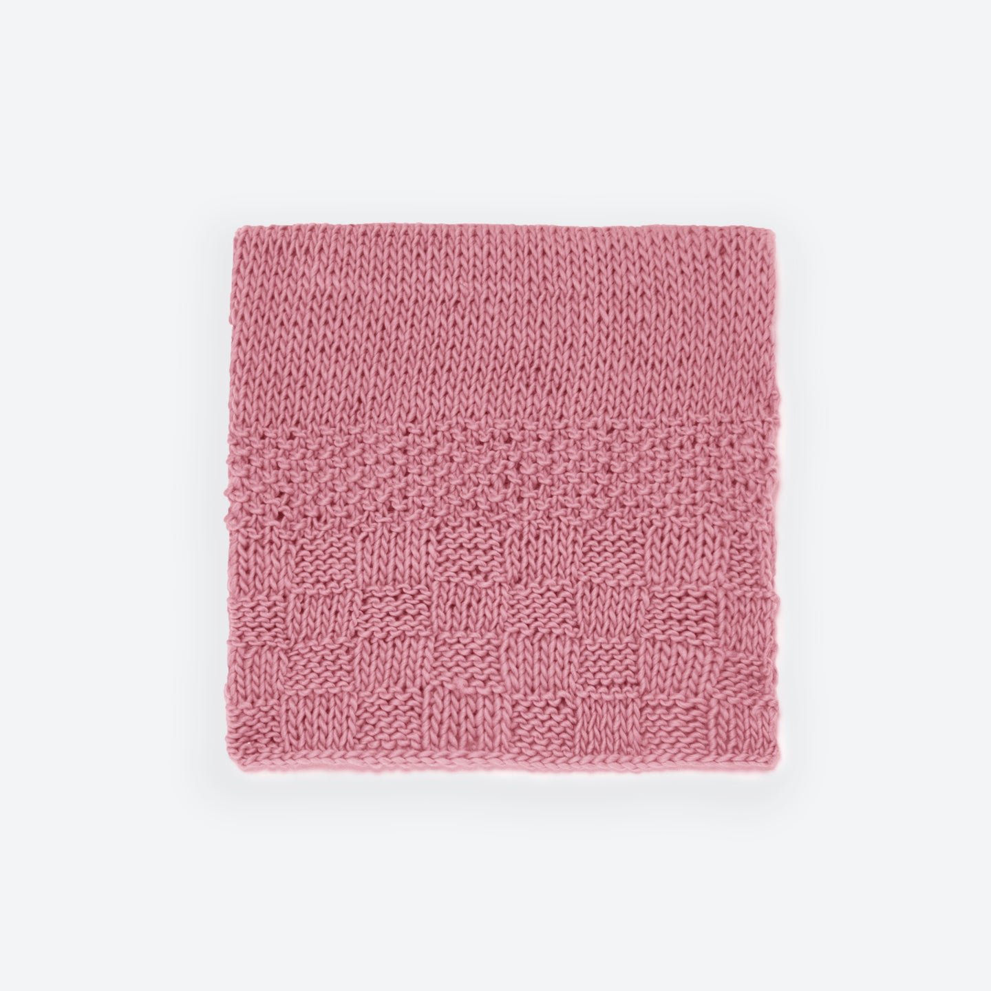 A Dust pink folded Bounty throw knitted from Stitch & Story beginner knitting kit in 100% merino wool The Chunky Wool.