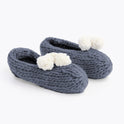 Fossil grey lola pom slippers with white pom pom knitted from Stitch & Story beginner knitting kit