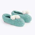 Stone Teal lola pom slippers with white pom pom knitted from Stitch & Story beginner knitting kit